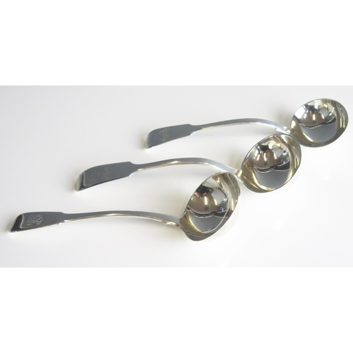 509 - Three assorted silver Fiddle pattern sauce ladles, various makers and dates, crested or initialled, ... 