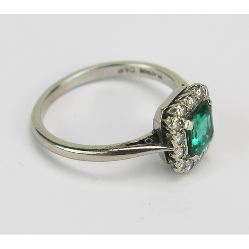 51 - A Platinum, Emerald and Diamond Ring, 5.05x4.55mm principal stone surrounded by c. 0.8mm brilliant c... 