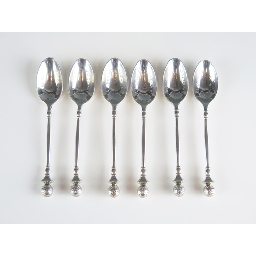 515 - A set of six George V silver golfing teaspoons, London, 1931, inscribed, with golf ball finials, 121... 