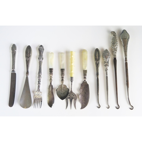 522 - A collection of silver and plated button hooks, butter knives, preserve spoon etc.