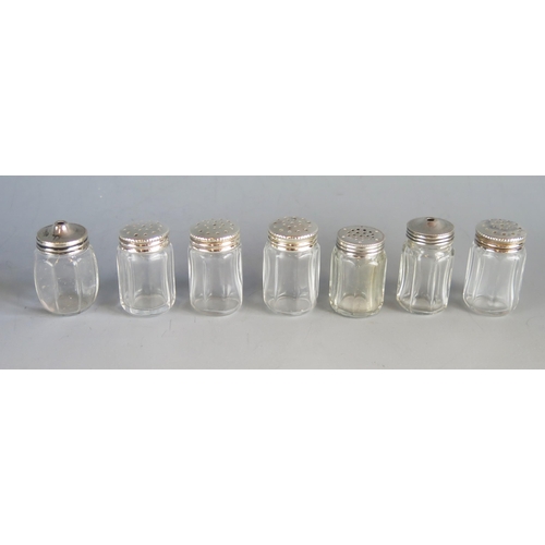 526 - Seven assorted clear glass and silver mounted individual peppers and salts. (7)