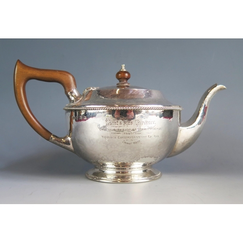 530 - A George V silver teapot, maker Albert Edward Jones, Birmingham, 1916, inscribed, of beaten circular... 