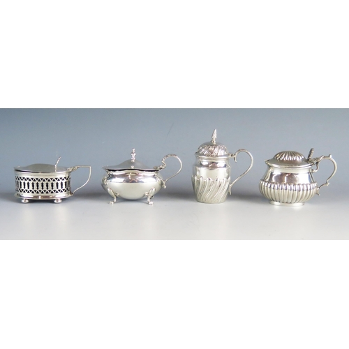 538 - Four assorted silver mustard pots and covers, various makers and dates, three having blue glass line... 