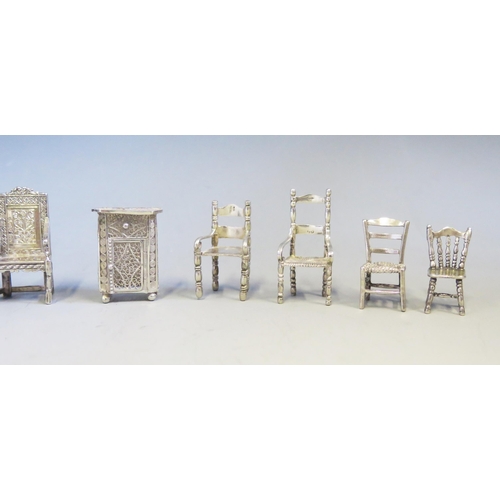 545 - A collection of continental silver miniature chairs and cabinet, various designs, total weight of si... 