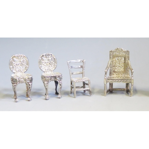 545 - A collection of continental silver miniature chairs and cabinet, various designs, total weight of si... 