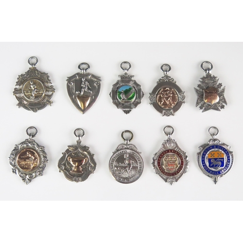 555 - A collection of silver fobs and sporting medallions, various makers and dates, total weight of silve... 