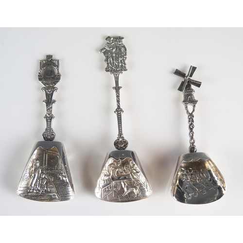 580 - Two Dutch silver and one plated caddy spoons, with embossed figural decorated bowls, and assorted de... 