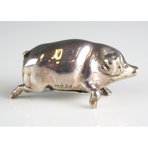 586 - A continental silver pepperette, bears import marks for London, 1903, in the form of a pig, 6cm long... 