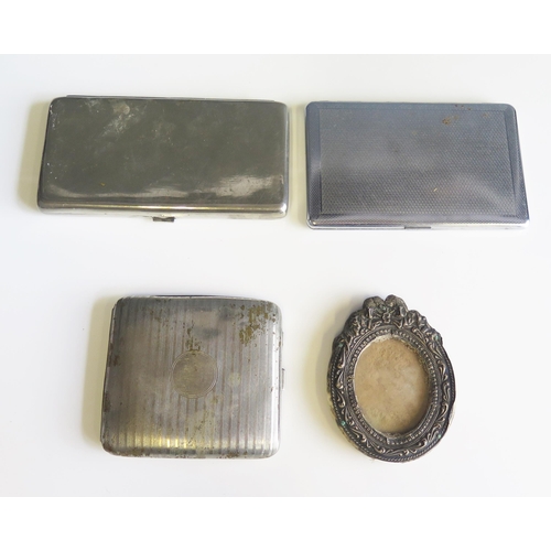 607 - A silver photograph frame, and three plated cigarette cases,