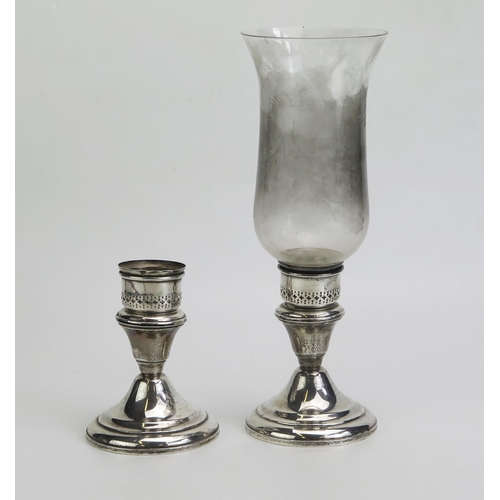 615 - A pair of sterling silver storm lamp bases, with pierced sconces, on a domed weighted base, one with... 