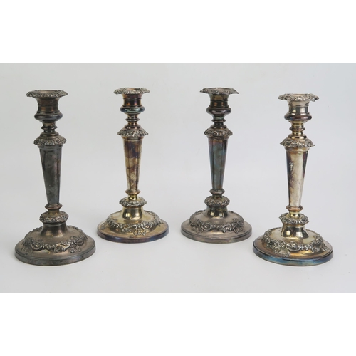 623 - A set of four plated candlesticks, with urn-shaped sconces on knopped and tapering stems on weighted... 