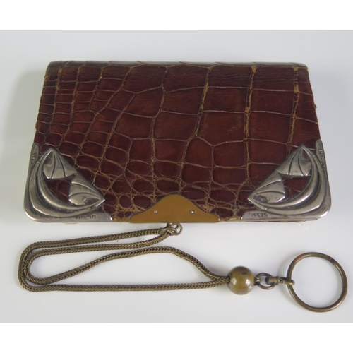 655 - An Art Nouveau period faux crocodile skin and silver mounted purse, bears import marks for Birmingha... 