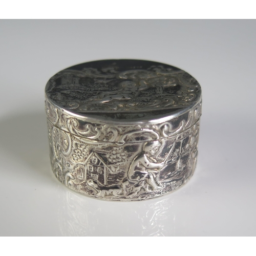 659 - A continental silver box, bears import marks, for London, 1895, of cylindrical form, with lift-off l... 