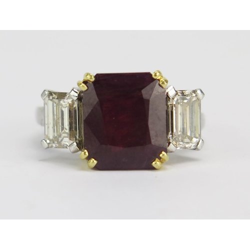 66 - A Ruby and Diamond Three Stone Ring in a precious white and yellow metal setting, 10.45x8.95mm princ... 