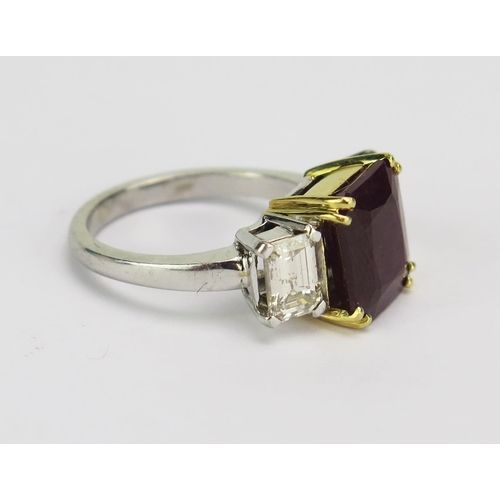 66 - A Ruby and Diamond Three Stone Ring in a precious white and yellow metal setting, 10.45x8.95mm princ... 