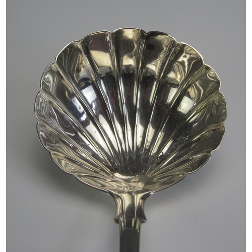 687 - A Victorian silver Fiddle pattern soup ladle, maker's mark rubbed and worn, London, 1842, with shell... 