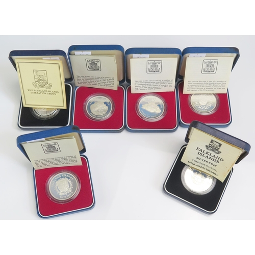 713 - Six Silver Commemorative Crowns including Falkland Islands, Jersey, Guernsey and Gibraltar