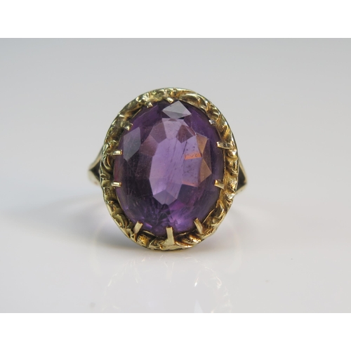 75 - An Antique Amethyst Ring in a precious yellow metal split shank setting, 19.8x16.5mm head, size J.75... 