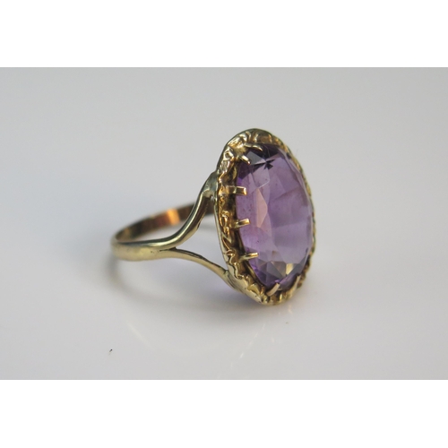 75 - An Antique Amethyst Ring in a precious yellow metal split shank setting, 19.8x16.5mm head, size J.75... 