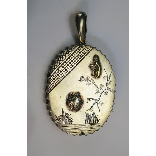 76 - A Victorian Silver and Precious Yellow Metal Locket  with foliate decoration and applied butterfly a... 