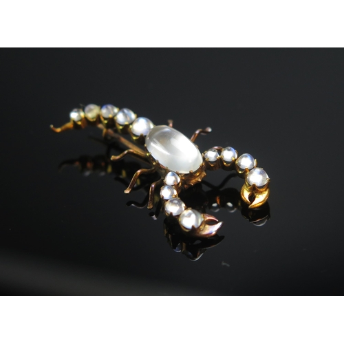 79 - A Moonstone Scorpion Brooch in a precious yellow metal setting, 38.8mm long, KEE tests as 18ct, 3.49... 