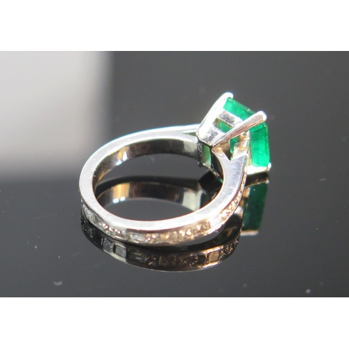 91 - A Platinum, Emerald and Diamond Ring, 8.6x8.2mm principal stone with diamonds set to the entire circ... 