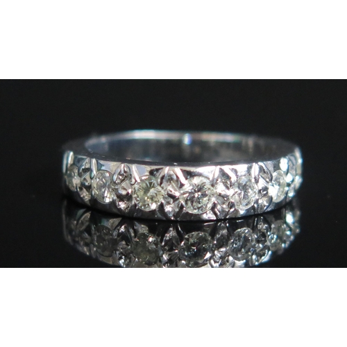 148 - An 18ct White Gold and Graduated Diamond Half Eternity Ring, size K.5, stamped 18CT, 5.76g