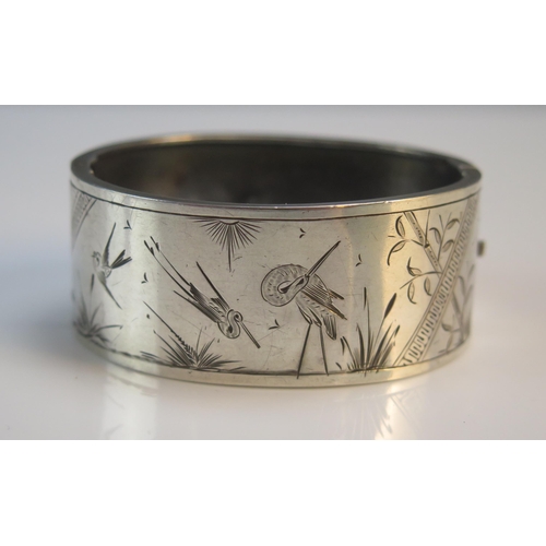 192 - An Antique Precious White Metal Hinged Bangle with aesthetic engraving, 25.87g