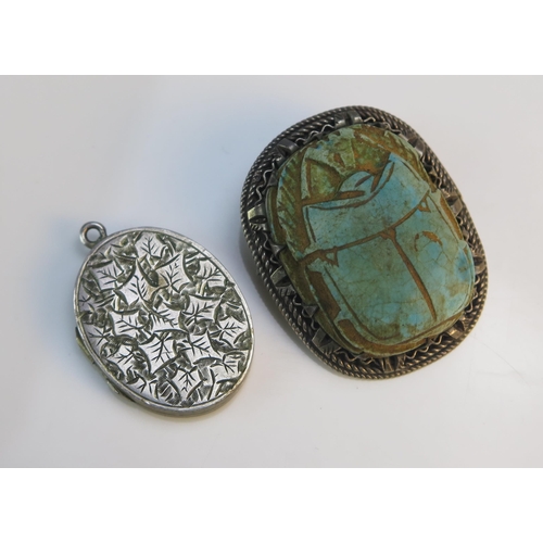 193 - A Victorian Silver Locket with chased ivy leaf decoration and an antique Egyptian faience scarab bee... 