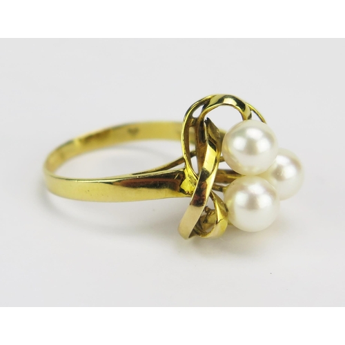 20 - A 14K Cultured Pearl Ring in a triangular entwined setting, 14.8mm head, size O, stamped `4K 585, 3.... 