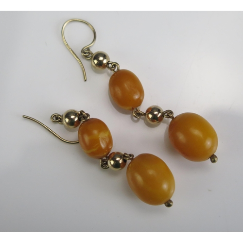 212 - A Pair of 9ct Gold and Amber Pendant Earrings, 58.5mm drop, 4g