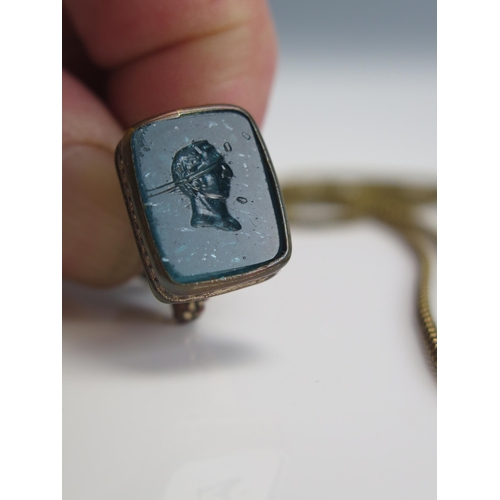 219 - A 19th Century Fob Seal with glass matrix with a male bust in profile and on a guard chain