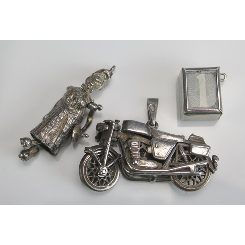 230 - A Silver 1 Shilling Note Charm, silver motorbike pendant and a precious white metal 'Judy' pendant, ... 