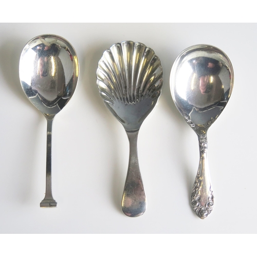 577 - three twentieth century silver caddy spoons, various makers and dates, total weight of silver 38gms,... 