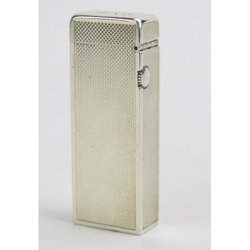 590 - Dunhill, a silver cased Rollagas lighter, bears import marks, 6.5cm high.