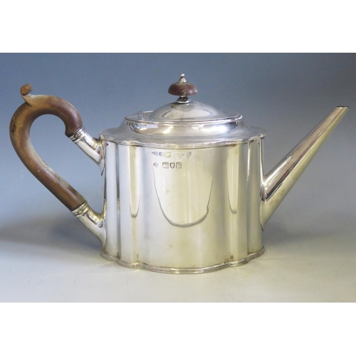 597 - A George V silver teapot, maker Horace Woodward & Co, London, 1912, crested, of oval outline, 28cm l... 