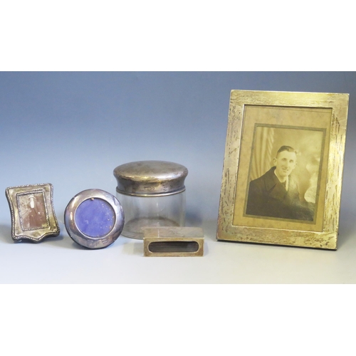 606 - A mixed collection of silver wares various makers and dates, includes matchbox holder, photograph fr... 