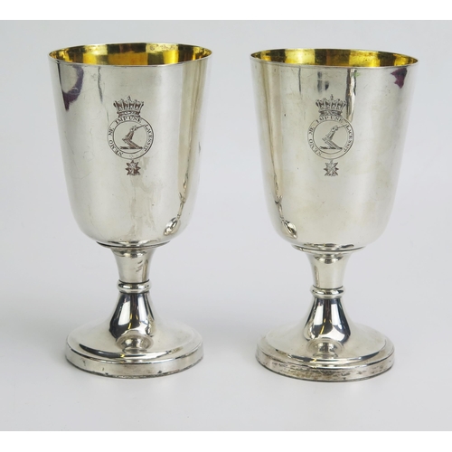 613 - A pair of Sheffield plate wine goblets, crested, with cylindrical tapering bowls on knopped stems an... 