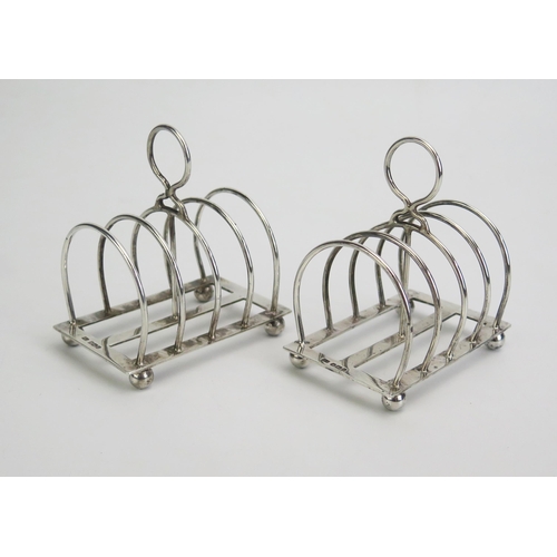 619 - A pair of Elizabeth II silver four-division toast racks, maker Atkin Brothers, Sheffield, 1962, with... 