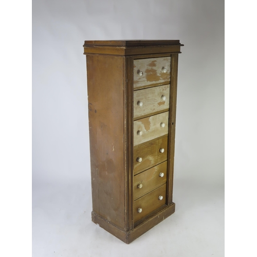 1514 - A Victorian stained pine Wellington chest, with moulded top and six short drawers with hinged stiles... 