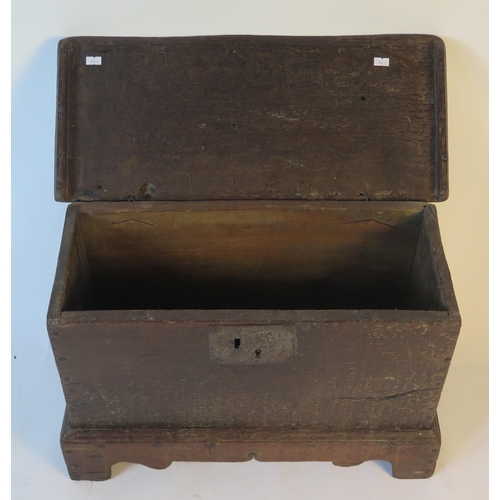 1579 - An 18th century small coffer, with rectangular hinged top, and plain sides on plinth base with brack... 