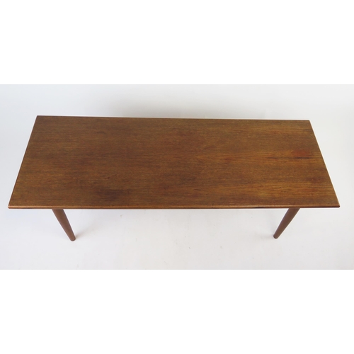 1626A - A teak effect occasional table, the rectangular top raised on turned legs, 135cm long, 51cm deep, 42... 