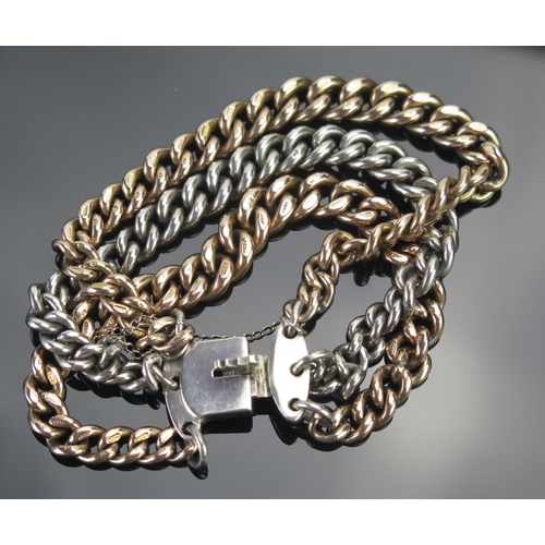 1 - A 9ct Gold and Silver Curb Link Bracelet, links stamped .375 and silver with lion mark, 64.54g