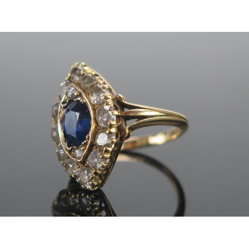 111 - An 18ct Gold, Sapphire and Diamond Marquis Ring, c. 7.4x6.5mm principal stone, surrounded by twelve ... 