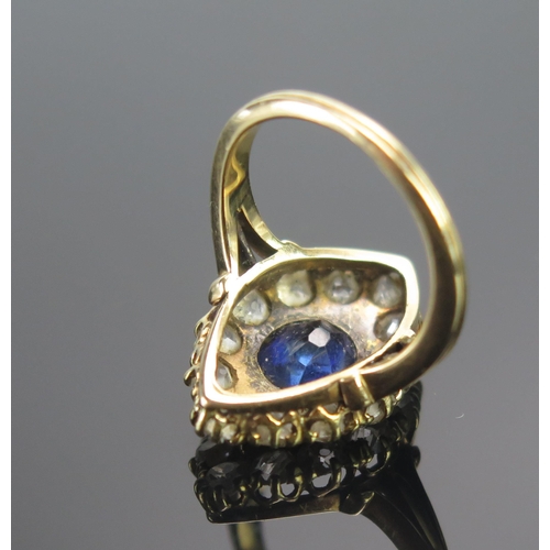 111 - An 18ct Gold, Sapphire and Diamond Marquis Ring, c. 7.4x6.5mm principal stone, surrounded by twelve ... 