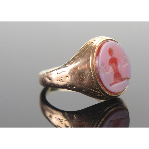 119 - An Antique Precious Yellow Metal Sheathed Hardstone Cameo Ring decorated with a lady holding a caste... 