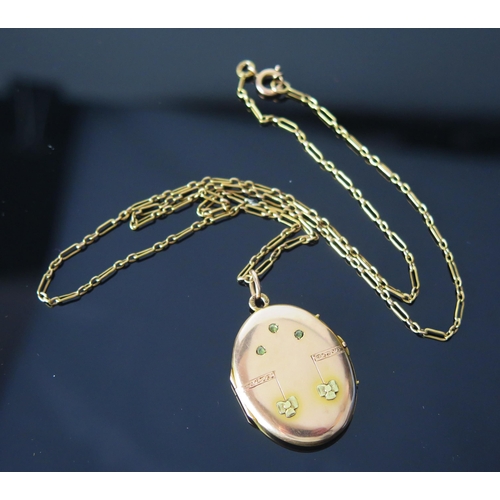 131 - A 14ct Gold Two Tone Locket set with three pale green stones, 41.4mm drop and on a 14ct gold chain, ... 