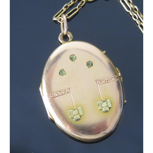 131 - A 14ct Gold Two Tone Locket set with three pale green stones, 41.4mm drop and on a 14ct gold chain, ... 