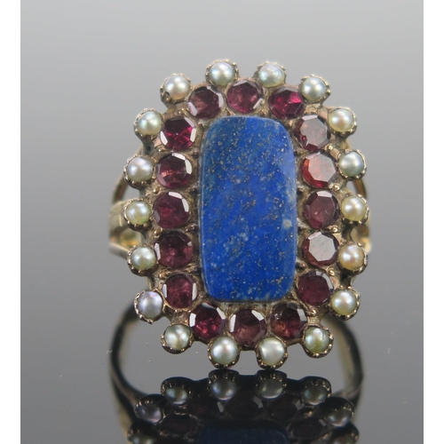 134 - A Large Lapis, Garnet and Seed Pearl Ring in a yellow metal setting, size N.5, 7g