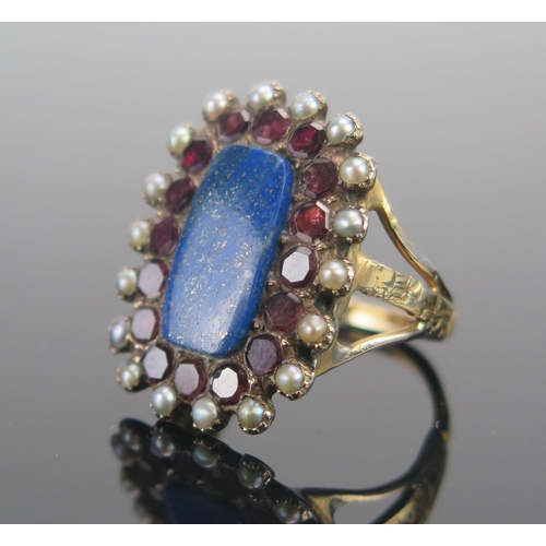 134 - A Large Lapis, Garnet and Seed Pearl Ring in a yellow metal setting, size N.5, 7g